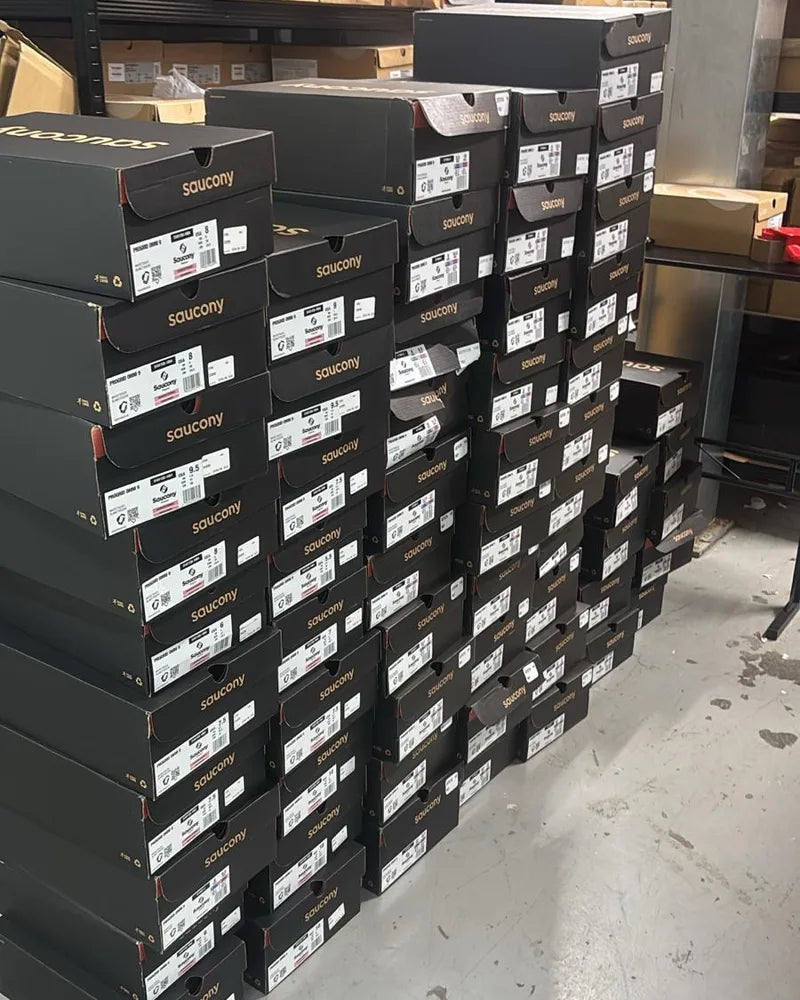 A wall of Saucony boxes in our stockroom